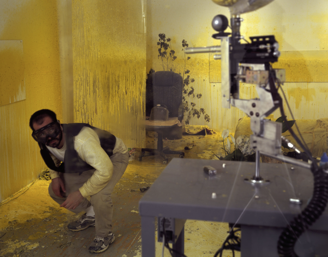 Wafaa Bilal in the yellow paint-covered Domestic Terror installation